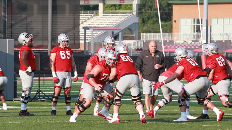 Greg Studrawa coaches the Ohio State Buckeyes offensive line as they began preseason camp for their 132nd season Aug. 4, 2021, in Columbus, Ohio. Harry Miller (76) is back from injury.