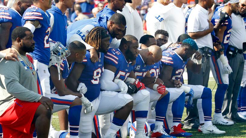 FILE - In this Sunday, Sept. 24, 2017, file photo, Buffalo Bills players take a knee during the playing of the national anthem prior to an NFL football game against the Denver Broncos in Orchard Park, N.Y. What began more than a year ago with a lone NFL quarterback protesting police brutality against minorities by kneeling silently during the national anthem before games has grown into a roar with hundreds of players sitting, kneeling, locking arms or remaining in locker rooms, their reasons for demonstrating as varied as their methods. (AP Photo/Jeffrey T. Barnes, File)