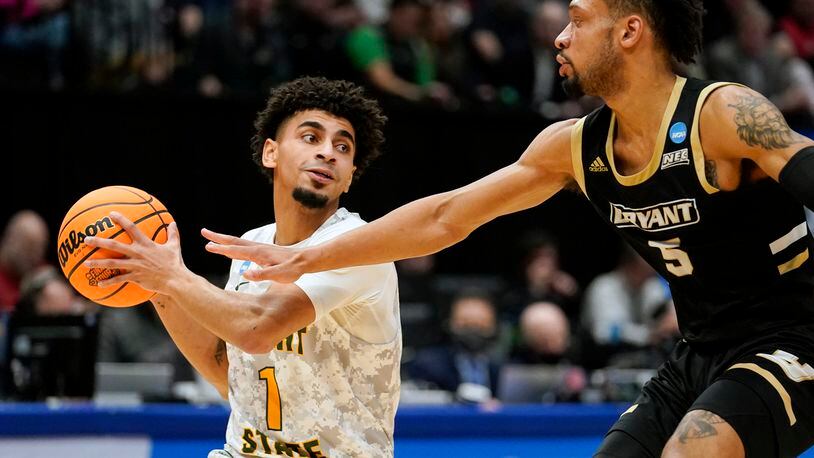 Wright State guard Trey Calvin (1) drives past Bryant's Charles Pride (5) during the second half of a First Four game in the NCAA men's college basketball tournament, Wednesday, March 16, 2022, in Dayton, Ohio. (AP Photo/Jeff Dean)