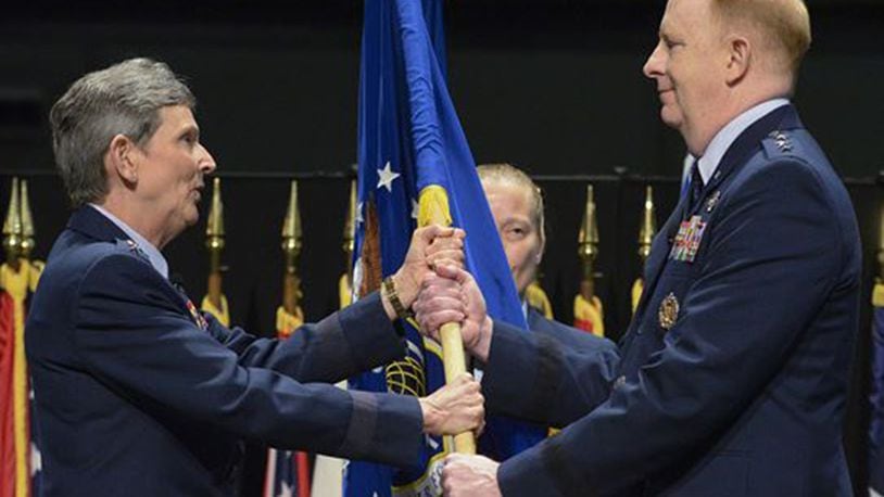 Gen. Ellen M. Pawlikowski, Air Force Materiel Command commander, presents the Air Force Life Cycle Management Center flag to Lt. Gen. Robert D. McMurry Jr. as he assumes command of the center May 2 during a ceremony in the National Museum of the U.S. Air Force at Wright-Patterson Air Force Base. (U.S. Air Force photo/Richard Oriez)
