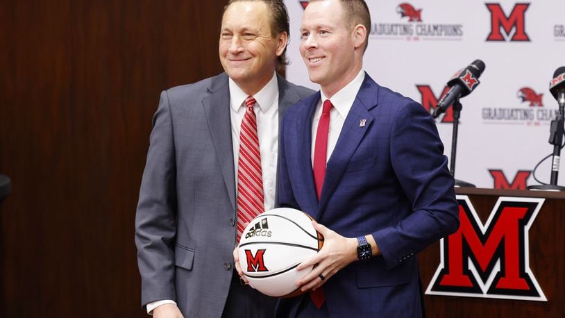 Miami University Director of Athletics David Sayler, left, stands with new Miami University Redhawks men's basketball coach Travis Steele during a press conference Friday, April 1, 2022 at the Randy Gunlock Family Athletic Center on the Miami University campus in Oxford. NICK GRAHAM/STAFF