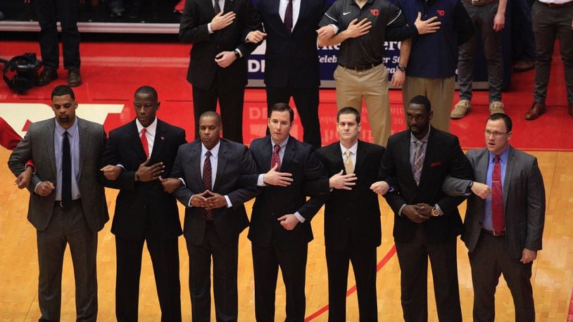 Dayton coaches, including Anthony Grant, second from left, stand for the national anthem before a game against Georgia State on Saturday, Dec. 16, 2017, at UD Arena. David Jablonski/Staff