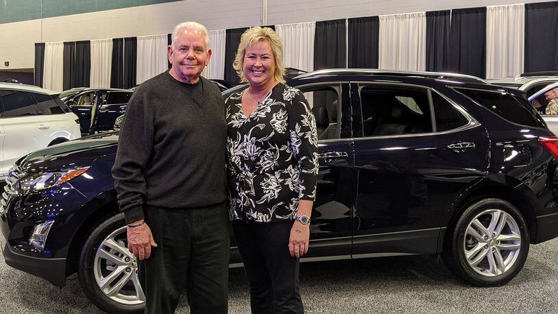 Joe Johnson of Joe Johnson Chevrolet, representing the Miami Valley Chevrolet Dealers, presents Darci Aselage of Sidney with the grand prize of a two-year lease on a 2020 Chevrolet Equinox at the 2020 Dayton Auto Show on March 23. The lease has an approximate value of beween $9,000 and $10,000. The Miami Valley Chevy Dealers have offered the prize for several years. This year’s show ran from Feb. 20 to 23, drawing thousands of attendees to the Dayton Convention Center to drool over more than 165 of the latest models and picture themselves behind the wheel of a new car, truck, crossover, hybrid or Harley-Davidson motorcycle. Contributed photo