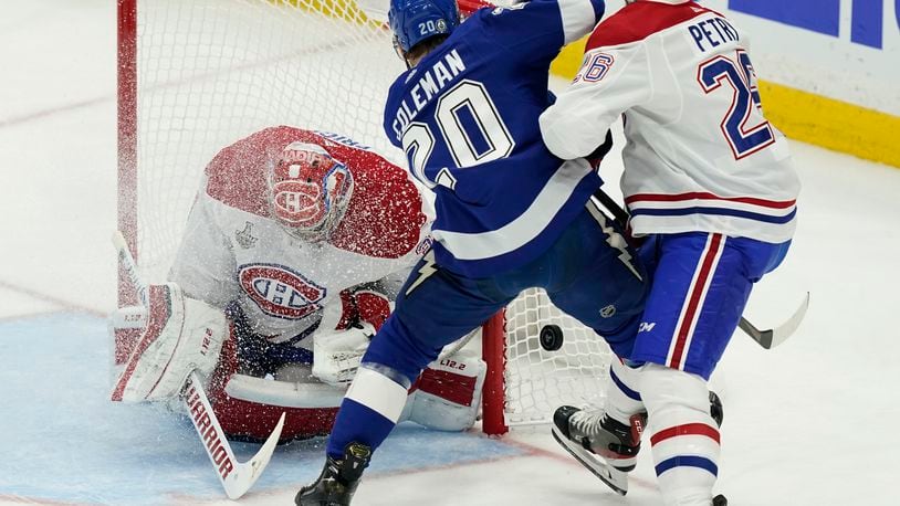 Montreal Canadiens defenseman Jeff Petry (26) checks Tampa Bay Lightning center Blake Coleman (20) next to Canadiens goaltender Carey Price (31) during the first period in Game 5 of the NHL hockey Stanley Cup finals, Wednesday, July 7, 2021, in Tampa, Fla. (AP Photo/Gerry Broome)