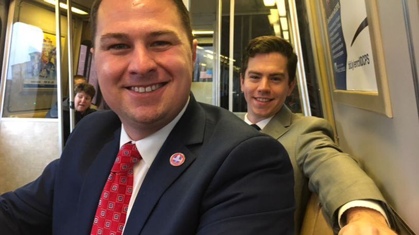 Nick Brusky, left, and Sam Buchan commute on the Metro on Friday. Brusky’s resignation as a Butler Twp. trustee took effect Friday. CONTRIBUTED