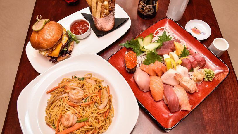 The Sushi and Sashimi sampler, The Woodford burger and fries, and Shrimp Lo Mein are displayed Wednesday, Jan. 17 at Basil 1791 that is now open on High Street in Hamilton. Basil 1791 offers a variety of dishes from sushi to traditional American fare. NICK GRAHAM/STAFF