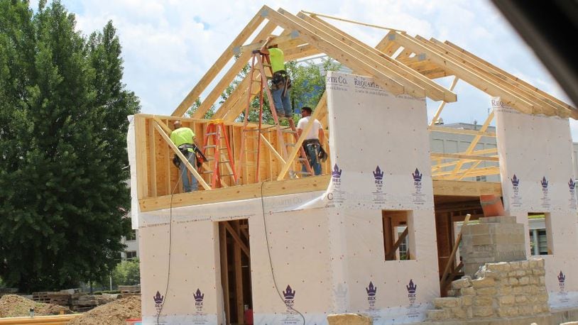 Crews work to build a home near the University of Dayton on South Main Street. CORNELIUS FROLIK / STAFF