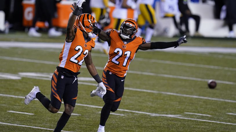 Cincinnati Bengals' William Jackson (22) and Mackensie Alexander (21) celebrate after Pittsburgh Steelers turned the ball over on downs during the second half of an NFL football game, Monday, Dec. 21, 2020, in Cincinnati. (AP Photo/Michael Conroy)