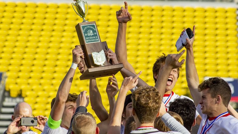 Tippecanoe players hoist their first state championship soccer trophy after the Red Devils defeated Warren Howland 1-0 in the Division II state final Sunday, Nov. 10, at MAPFRE Stadium in Columbus. Jeff Gilbert/CONTRIBUTED