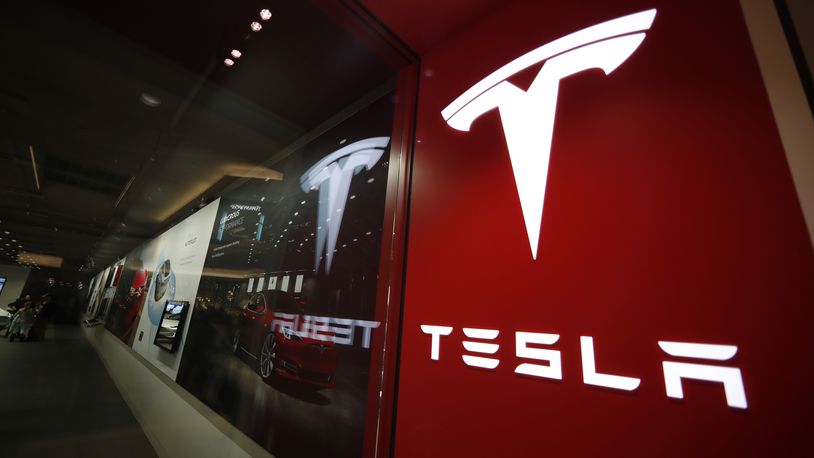 FILE - The Tesla logo is displayed at the company's store in Cherry Creek Mall, Feb. 9, 2019, in Denver. Tesla's stock tumbled below $150 per share Thursday, April 18, 2024, giving up all of the gains made over the past year as the electric vehicle maker reels from falling sales and steep discounts intended to lure more buyers. (AP Photo/David Zalubowski, File)