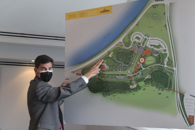 Brady Kress, president and CEO of Dayton History, points out the railroad on a map of the 65-acre Carillon Historic Park.  CORNELIUS FROLIK / STAFF