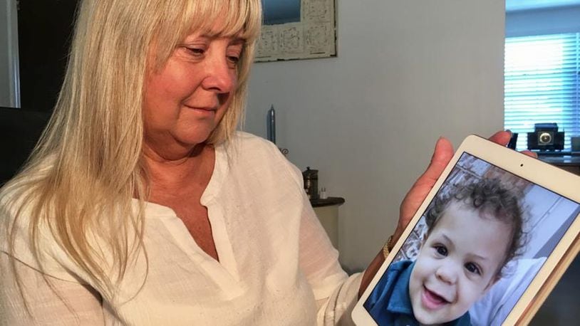 Lucy Ashburn poses with a photo of her 2-year-old grandson Kaeden, who was was taken to Dayton Children s Medical Center for severe scalding burns over a significant portion of his body, last year caused by his stepfather who was sentenced on Friday. (Chuck Hamlin/STAFF PHOTO)