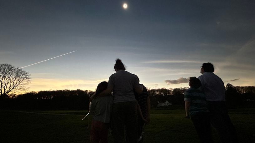 Justin Kasper, Norman Kasper, Hannah Kasper Levinson, Dahlia Levinson and Noah Levinson watch the eclipse at totality in Oakwood. Contributed photo by Stephen Levinson.