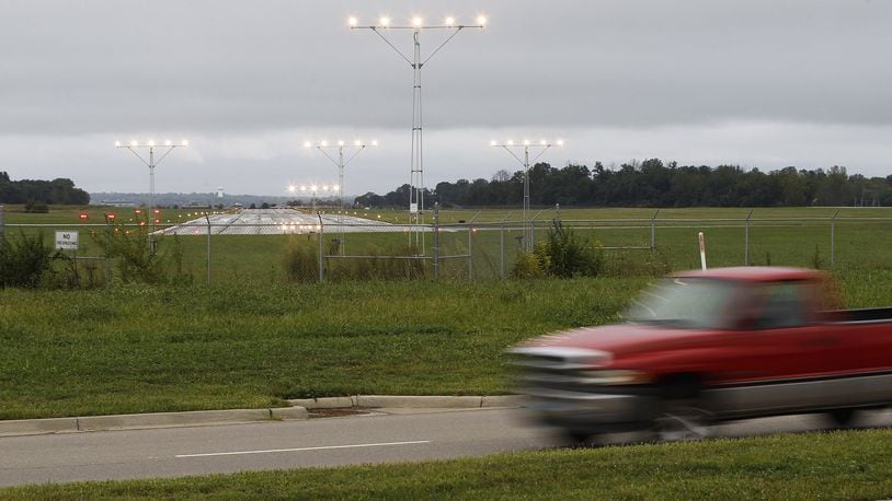 Dayton-Wright Brothers Airport plans call for relocating a portion of Austin Boulevard north of the airport to give airplanes more room for takeoffs and landings. Landing approach lights for the runway are currently located on both sides of Austin Road with the runway a few hundred feet away. TY GREENLEES / STAFF