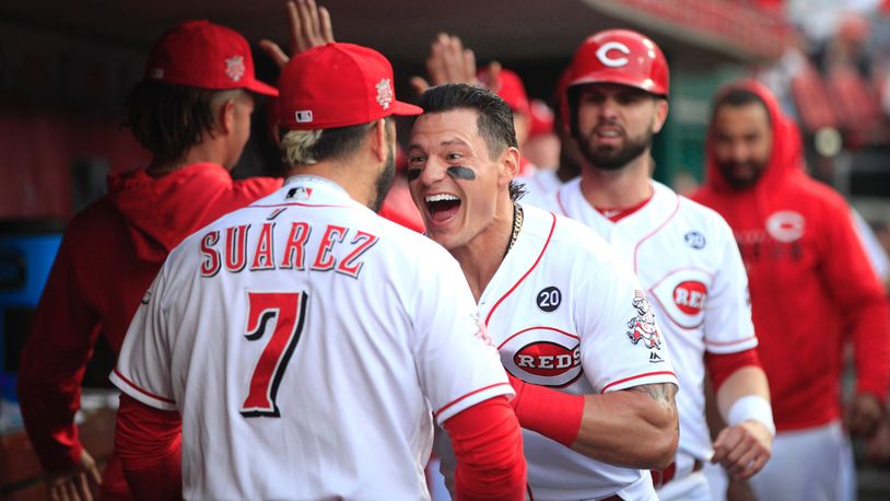 The Reds’ Derek Dietrich celebrates with Eugenio Suarez after hitting a three-run home run against the Giants on Friday, May 3, 2019, at Great American Ball Park in Cincinnati. David Jablonski/Staff