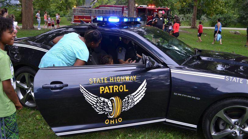 Children take a look inside an Ohio State Patrol vehicle during the National Night Out event. FILE