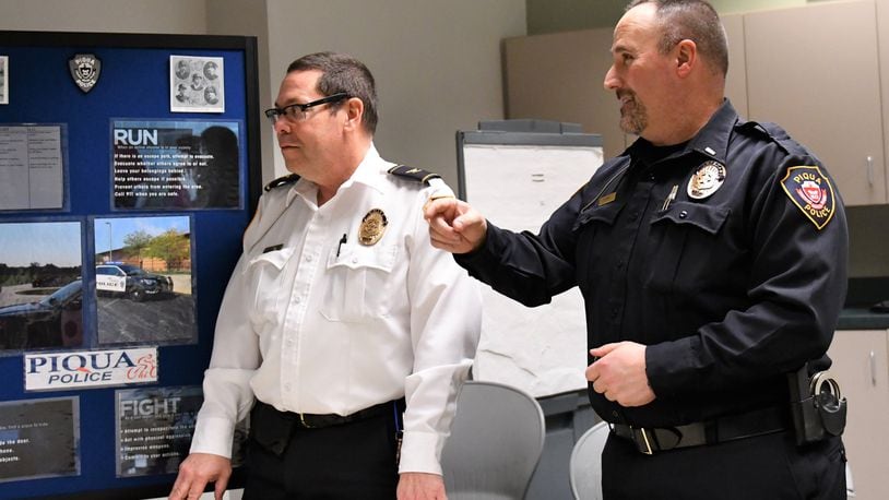 Retiring Piqua Police Chief Bruce Jamison (left) discusses a department recruiting presentation with Lt. Rick Byron, who will be the next chief of the Miami County city. (Contributed)