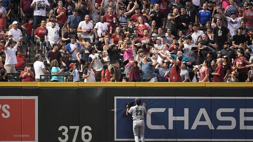 PHOENIX, AZ - MAY 28:  Adam Duvall #23 of the Cincinnati Reds watches as fans reach for the home run ball hit by John Ryan Murphy #36 of the Arizona Diamondbacks (not pictured) during the fourth inning of the MLB game at Chase Field on May 28, 2018 in Phoenix, Arizona. MLB players across the league are wearing special uniforms to commemorate Memorial Day.  (Photo by Jennifer Stewart/Getty Images)