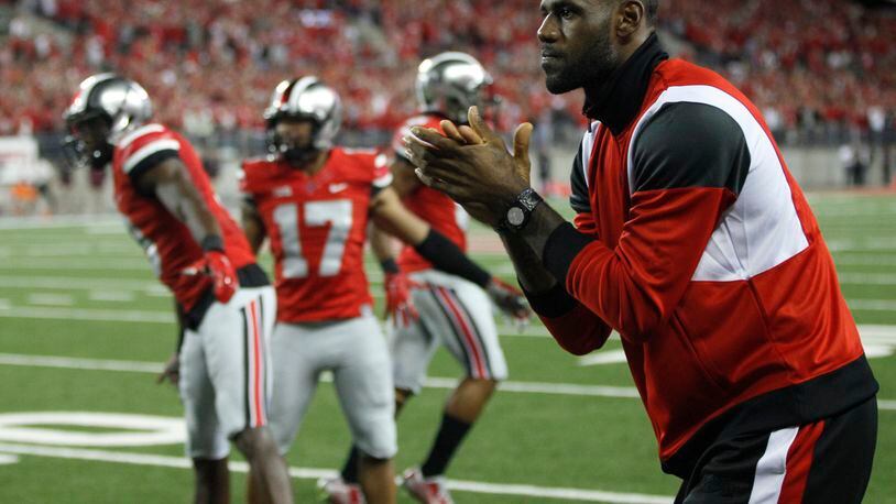 LeBron James cheers from the Ohio State sideline after a touchdown run by Ezekiel Elliott in the fourth quarter on Saturday, Sept. 6, 2014, at Ohio Stadium in Columbus. David Jablonski/Staff