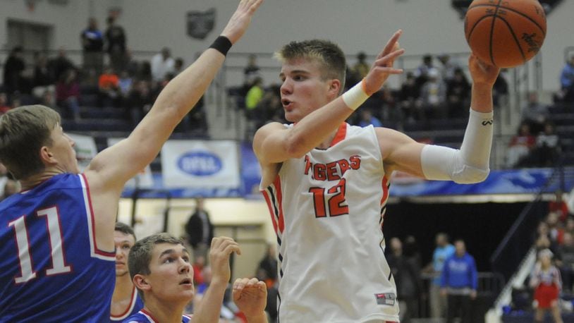 Versailles junior and OSU commit Justin Ahrens (with ball) tallied 26 points and nine rebounds in a 61-56 defeat of Tri-Village in the Premier Health Flyin’ to the Hoop at Trent Arena in Kettering last season. MARC PENDLETON / STAFF