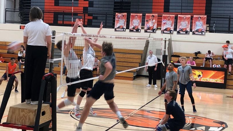A Fairmont player spikes the ball past two Beavercreek blockers during their volleyball match April 4, 2019. CONTRIBUTED