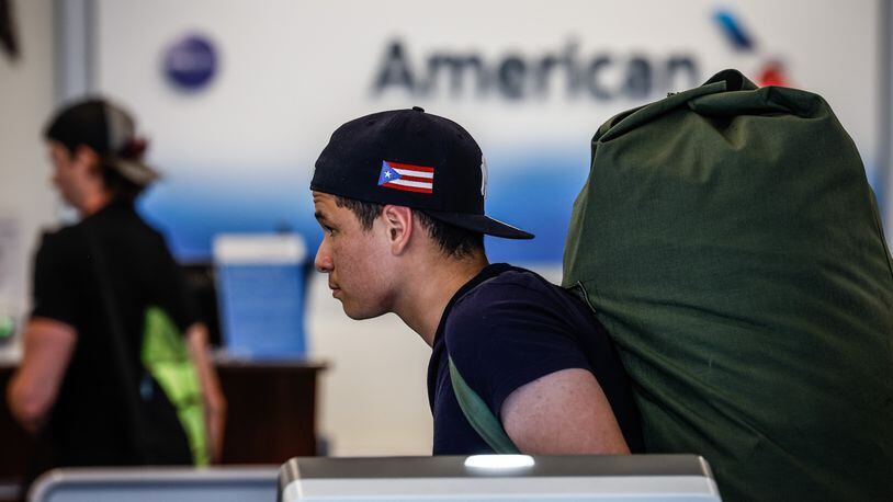 Pedro Figueroa, from the Bronx in New York City, waits inline at American Airlines ticket counter at the Dayton International Airport Friday July 15, 2022. JIM NOELKER/STAFF
