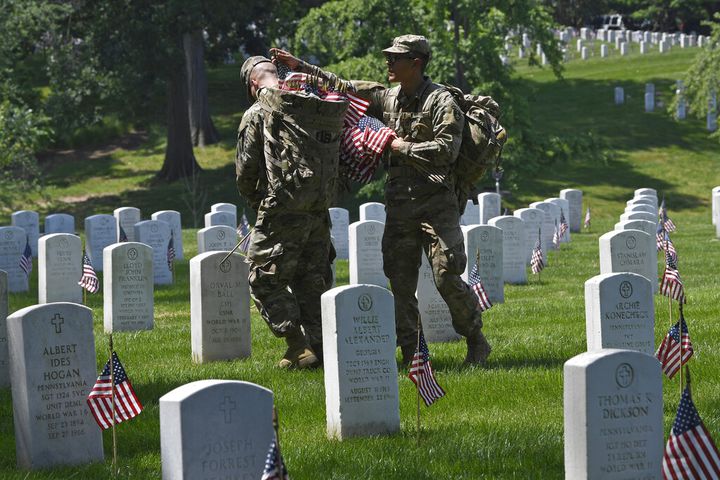 Soldiers place flags at Arlington National Cemetery for Memorial Day