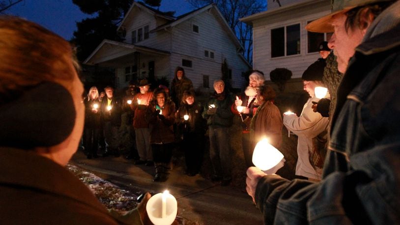 Neighbors and friends are shown at a candlelight vigil for Klonda Richey in February 2015 in front of her former home on Bruce Avenue in Dayton. She was mauled to death by neighbors’ dogs, and a civil lawsuit in the case continues against Montgomery County. FILE