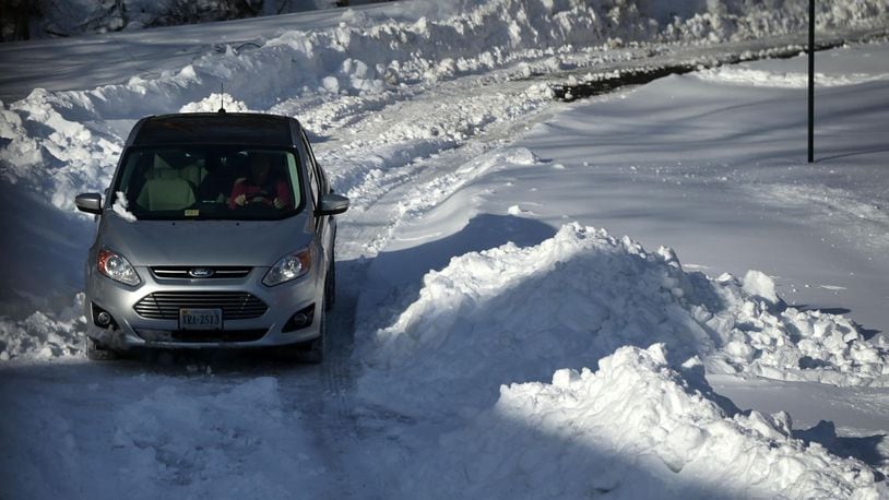 FILE PHOTO: A driver navigates on a snow-covered driveway.