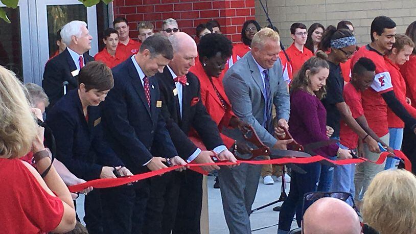 Students, staff and school board members participate in the official ribbon cutting ceremony at the new Fairfield Freshman School on Saturday, Sept. 9. The ribbon cutting was part of the dedication ceremonies for the community. ED RICHTER/STAFF