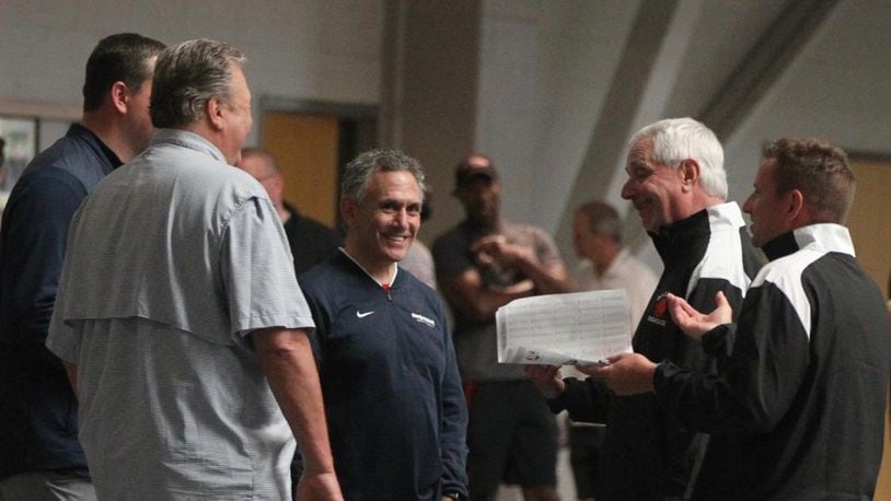 Keith Dambrot, center, talks to Bob Huggins, second from left, and other coaches at a recruiting even for top Ohio players at Capital University on June 29, 2019, in Bexley.