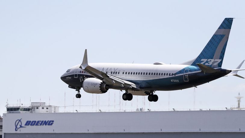 A Boeing 737 MAX jet heads to a landing at Boeing Field following a test flight Monday, June 29, 2020, in Seattle. The jet took off from the airport earlier in the day, the start of three days of re-certification test flights that mark a step toward returning the aircraft to passenger service. (AP Photo/Elaine Thompson)