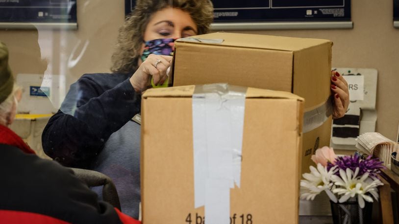 Dayton USPS Sales and Service Associate Kim Bowser ships packages Tuesday Nov. 9, 2021. The major carriers have all released their holiday shipping deadlines for 2021. JIM NOELKER/STAFF