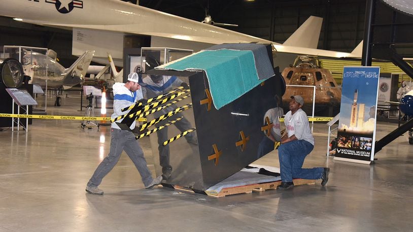 Exhibit specialists Taylor Burkhardt (left) and Quinton Johnson install the Global Positioning System exhibit in the Space Gallery at the National Museum of the U.S. Air Force. (U.S. Air Force photo/Ken LaRock)
