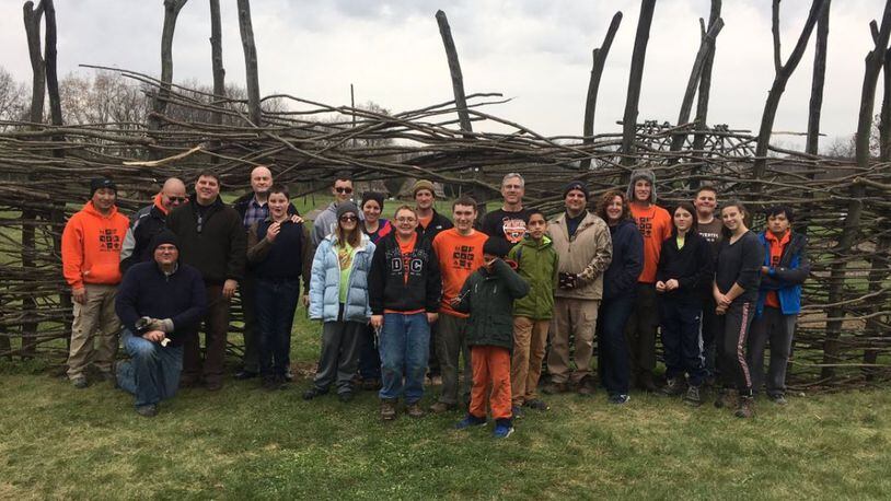 For his Eagle Scout project, Beavercreek sophomore Mason Kennedy, fifth from the right, got dozens of people to help him rebuild the stockade at the SunWatch Indian Village. CONTRIBUTED PHOTO