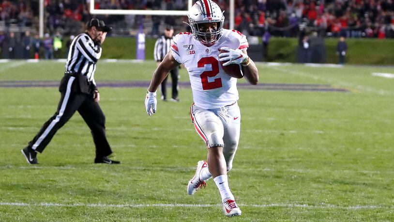 Ohio State running back J.K. Dobbins scores on a pass from quarterback Justin Fields during the first half of an NCAA college football game against Northwestern, Friday, Oct. 18, 2019, in Evanston, Ill. (AP Photo/Charles Rex Arbogast)