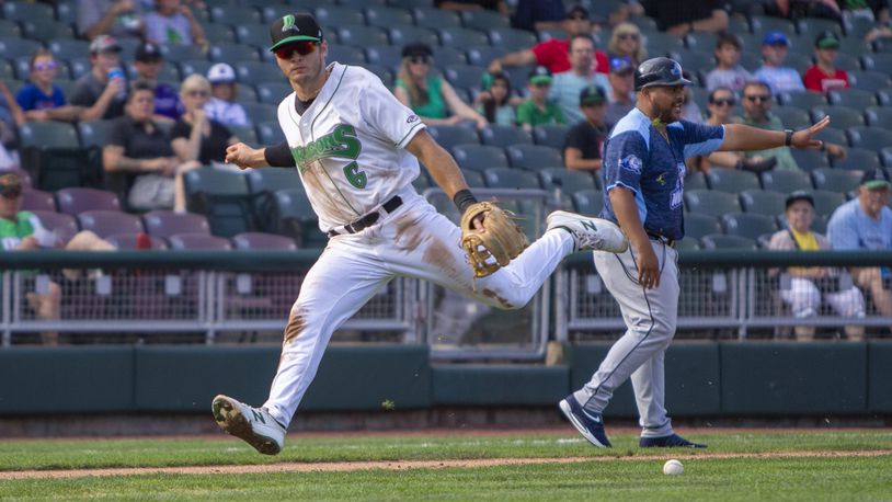 Dragons third baseman Tyler Callihan overruns a bunt during the first game of a doubleheader Thursday against West Michigan. The ball got too far away from Callihan and a runner scored from third in the 7-3 loss.