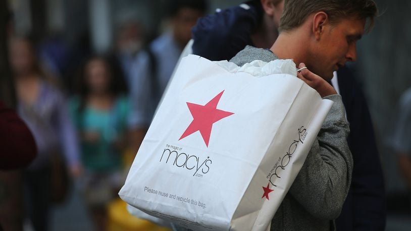 Caption:CHICAGO, IL - AUGUST 14: A shopper carries a purchase from Macy's along the Magnificent Mile shopping district on August 14, 2013 in Chicago, Illinois. Macys reported lower than-expected second quarter sales today and cut their profit outlook for the year. Some analysts fear the disappointed news will reverberate throughout the retail sector because Macy's is looked at as a barometer of spending among middle- to upper-income shoppers. (Photo by Scott Olson/Getty Images)