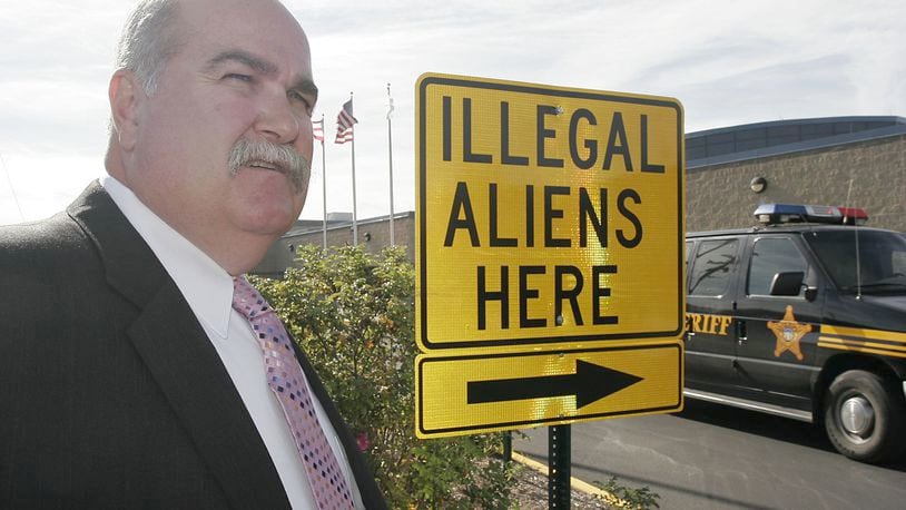 Butler County Sheriff Richard Jones stands next to a illegal aliens sign he had placed in the parking lot of the Butler County Sheriff’s Department, Thursday, Nov. 3, 2005 in Hamilton, Ohio. Jones says federal authorities aren’t doing enough to enforce immigration laws.