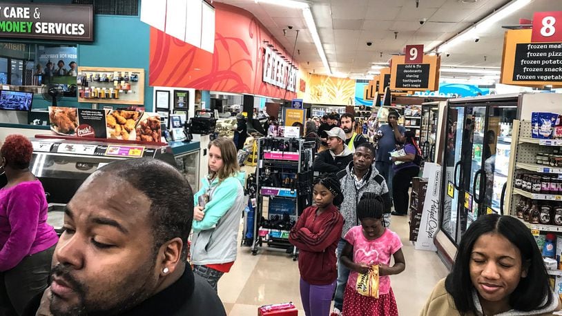 Shoppers at the Kroger’s on Wayne Ave. waited in line over a half and hour to get provisions Thursday night. Because of the coronavirus, the City of Dayton issued a state of emergency. JIM NOELKER/STAFF