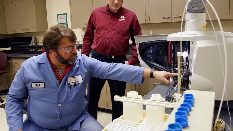 Lab Analyst Rick Pennington, left, and Lab Services Manager Jim Davis,Montgomery County Environmental Services, monitor a lead testing machine. The county offers lead testing of water from private residences or water wells for $12. TY GREENLEES / STAFF