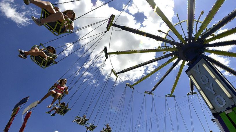 Clark County Fair goers ride the swings on the midway under a beautiful sky Friday. BILL LACKEY/STAFF