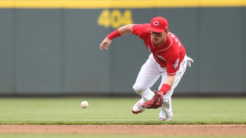 Reds second baseman Scooter Gennett fields a ball against the Nationals on Saturday, March 31, 2018, at Great American Ball Park in Cincinnati. David Jablonski/Staff