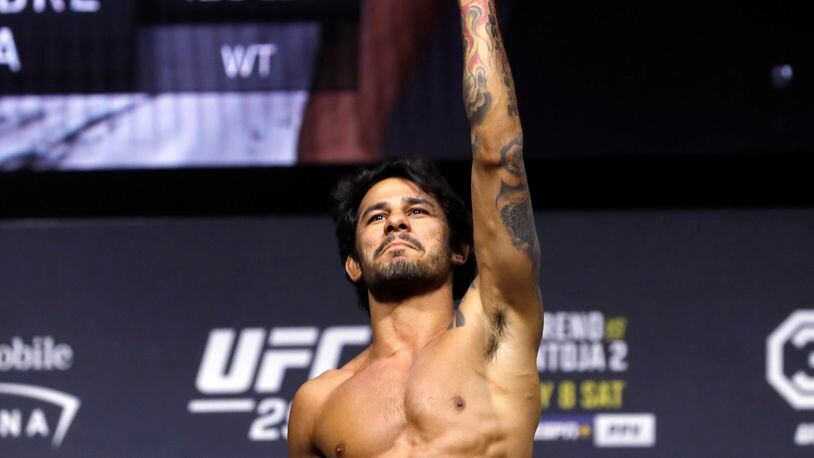 FILE - Alexandre Pantoja poses on the scale during a ceremonial weigh-in for the UFC 290 mixed martial arts event July 7, 2023, in Las Vegas. Flyweight champion Pantoja is scheduled to meet Steve Erceg in the main event at UFC 301 in Rio de Janeiro, Saturday, May 4, 2024. (Steve Marcus/Las Vegas Sun via AP, File)