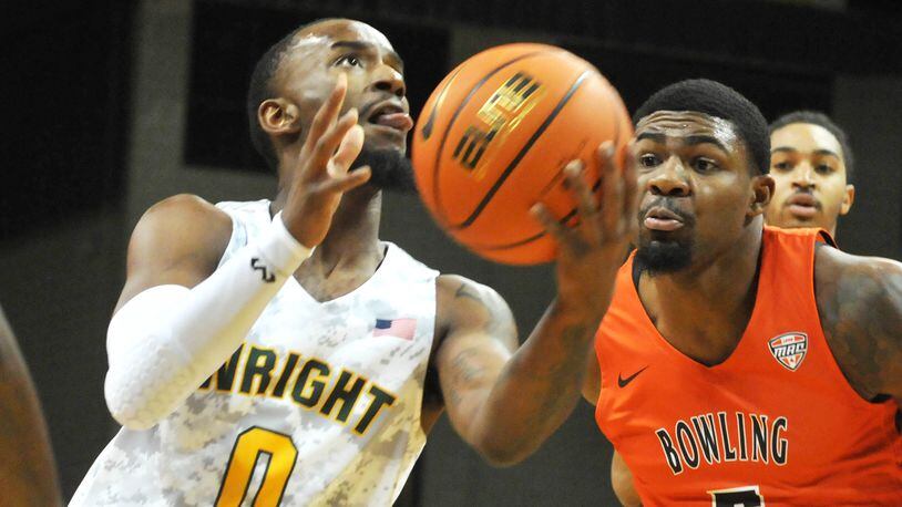 Wright State's Amari Davis drives for the basket against Bowling Green's Rashaun Agee during a non-conference game at the Nutter Center on Tuesday, Nov. 15. DAVID A. MOODIE/CONTRIBUTING PHOTOGRAPHER