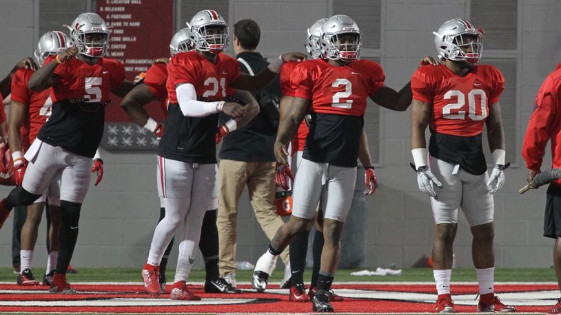 Ohio State players (left to right) Johnnie Dixon, Parris Campbell, Dontre Wilson and Mike Weber stretch before spring football practice on Tuesday, March 29, 2016, at the Woody Hayes Athletic Center in Columbus. David Jablonski/Staff