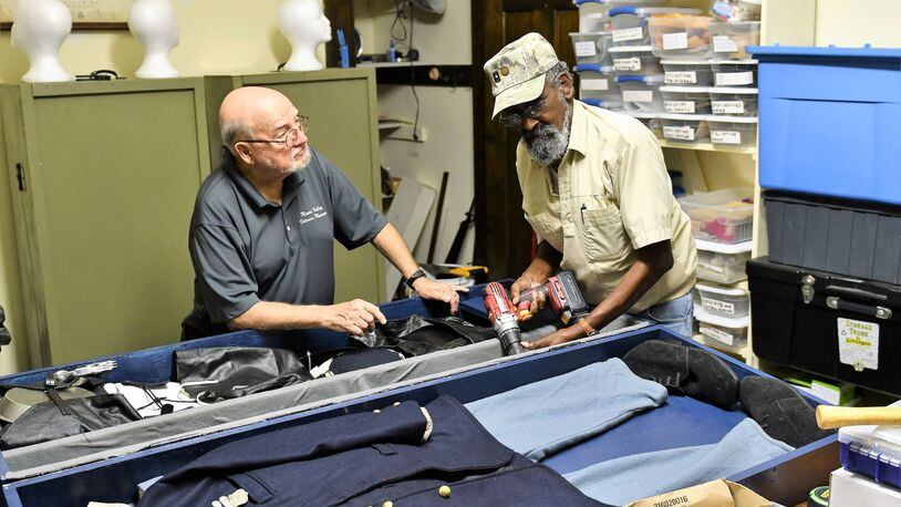 Terry Purke (left) and Lou Hart work on putting together the Civil War box for the History in a Box program offered by the Miami Valley Veterans Museum. CONTRIBUTED