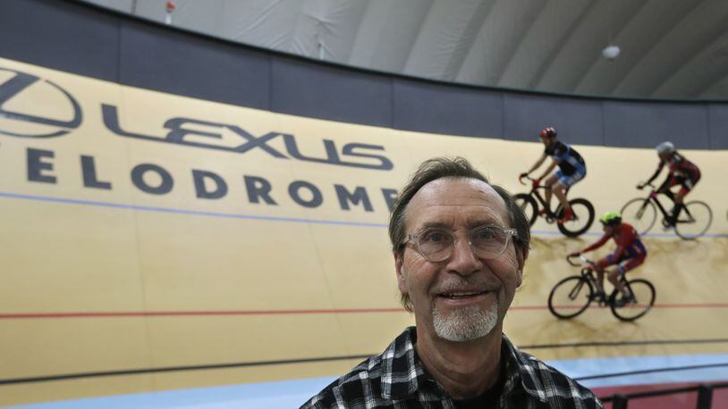 In a photo from Thursday, Jan. 18, 2018, velodrome designer Dale Hughes, who designed and built the Lexus Velodrome, poses with riders on the track in Detroit. The indoor cycling track is expected to draw bike riders from other cold-weather states and across the U.S. while giving inner-city youth an opportunity to participate for free in the fast-moving and growing sport. The Lexus Velodrome joins a training facility in Colorado Springs and a venue in Los Angeles as the only indoor velodromes in the U.S. (AP Photo/Carlos Osorio)