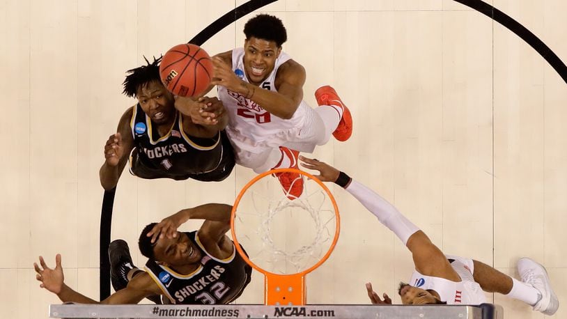 Xeyrius Williams (#20) of the Dayton Flyers battles Wichita State's Zach Brown for a rebound during the first round of the NCAA Baketball Tournament at Bankers Life Fieldhouse on March 17, in Indianapolis, Indiana.