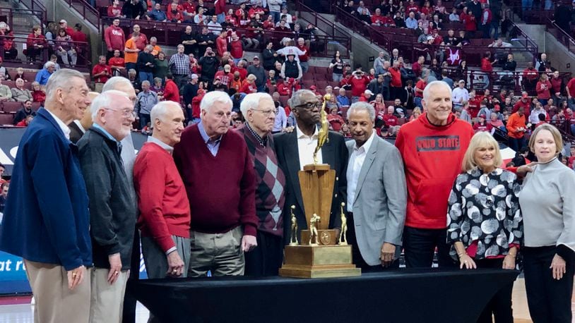 Bob Knight (maroon sweater), Jerry Lucas (third from right) and the rest of the Buckeyes pose with the 1960 national championship trophy at Ohio State in 2020. Marcus Hartman/STAFF